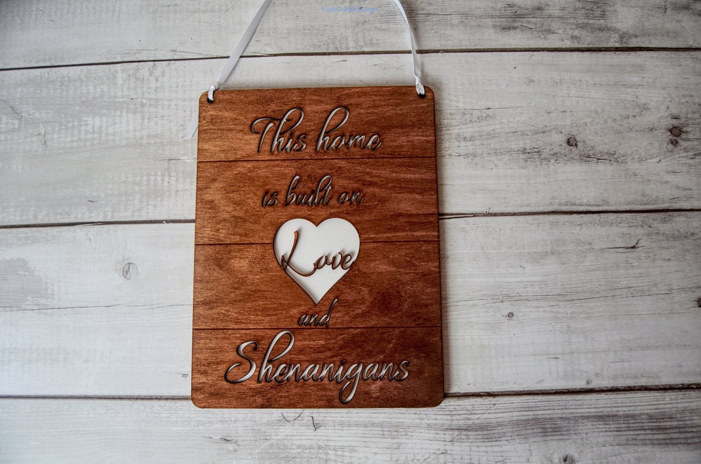 Wooden this home is built on love and shenanigans sign