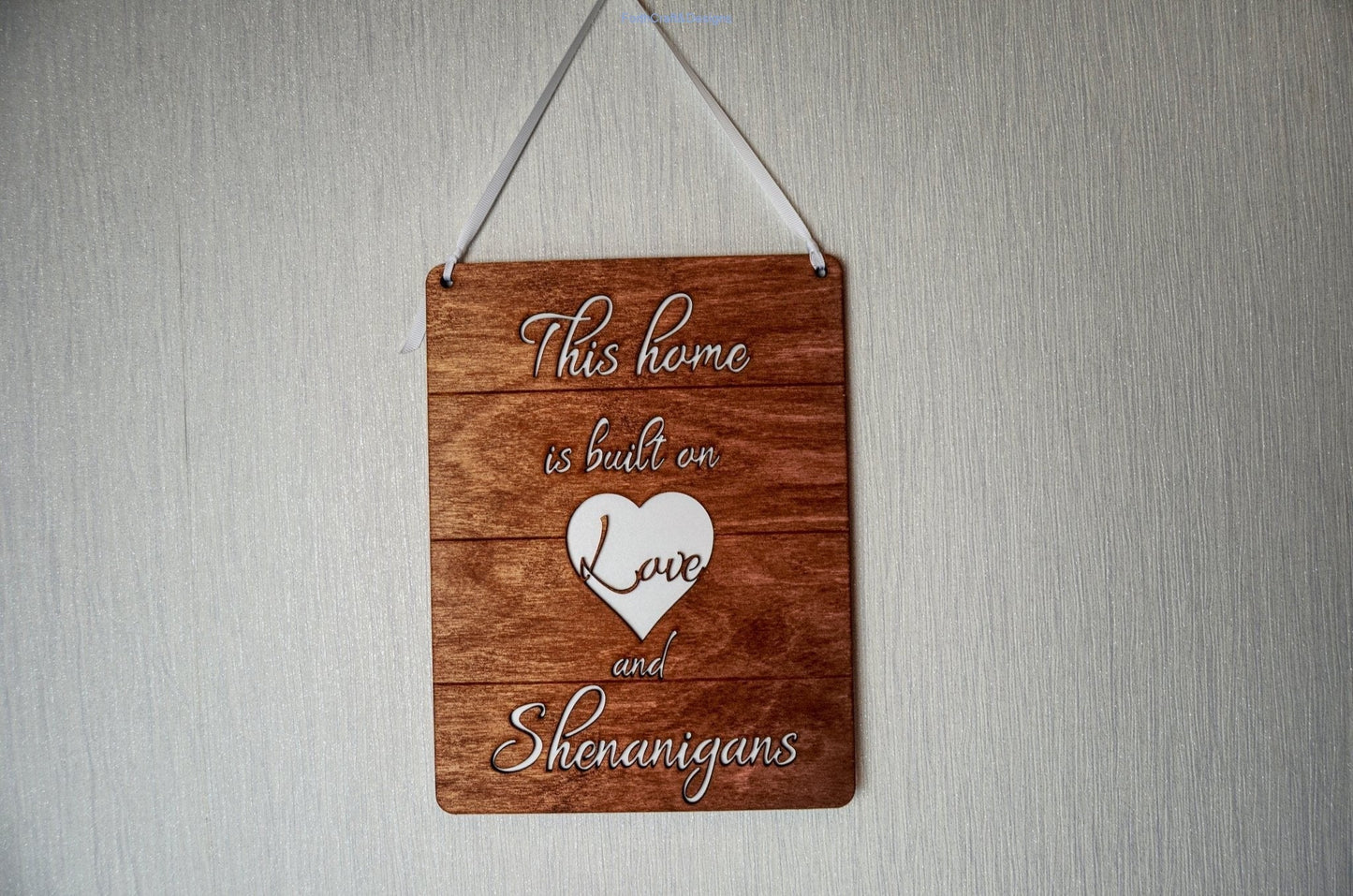 Wooden this home is built on love and shenanigans sign