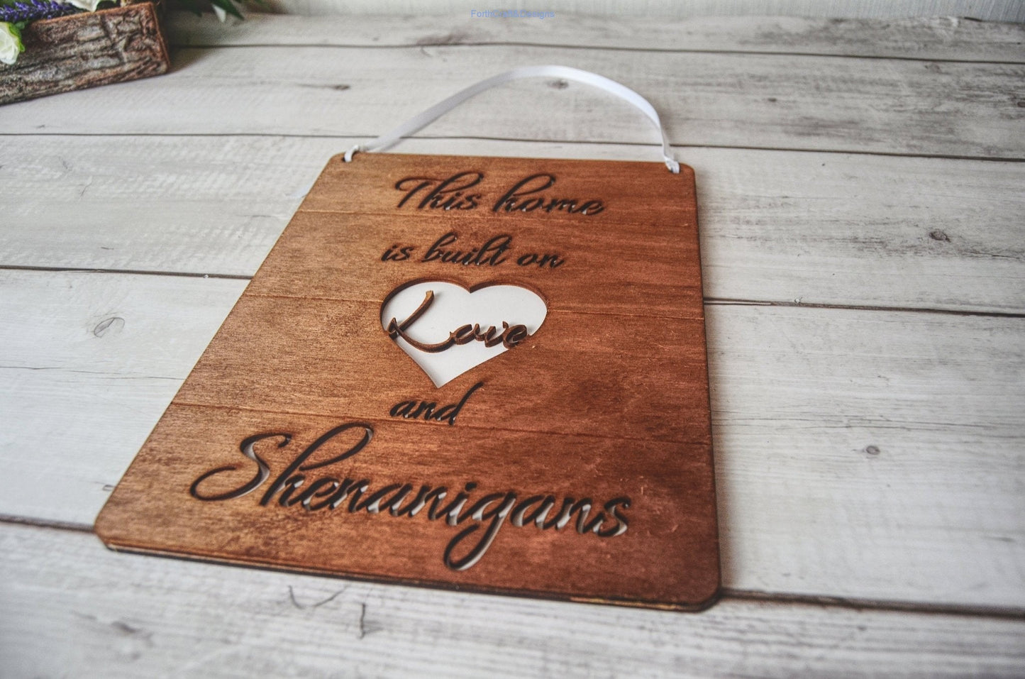 Wooden this home is built on love and shenanigans sign