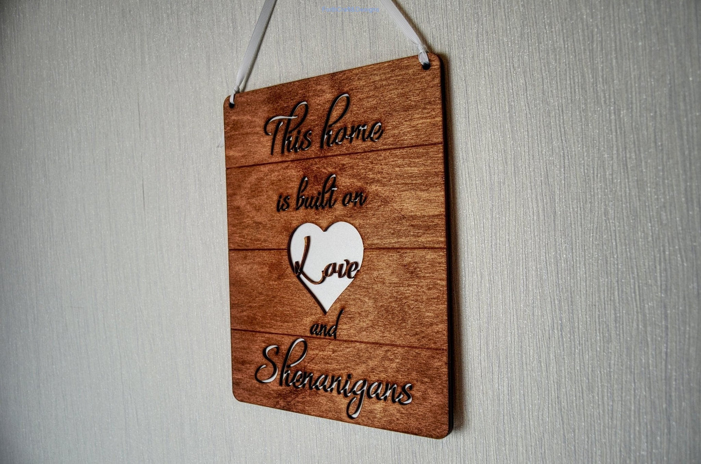 Wooden this home is built on love and shenanigans sign