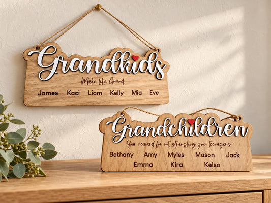 Grandkids and Grandchildren personalised wooden plaques with raised white script, red hearts and engraved names, displayed on a wall and console.