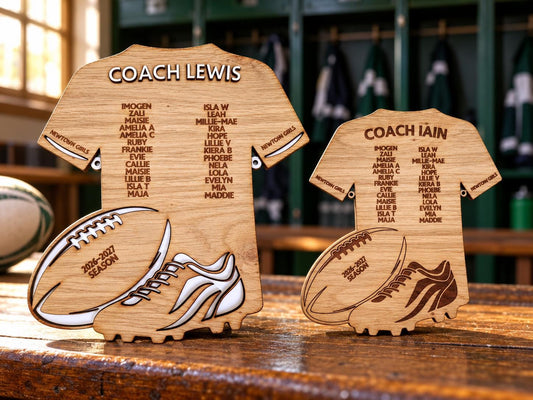 Large and small personalised wooden rugby coach plaques together; large has raised white name and white ball and boot details, small has engraved name and artwork.