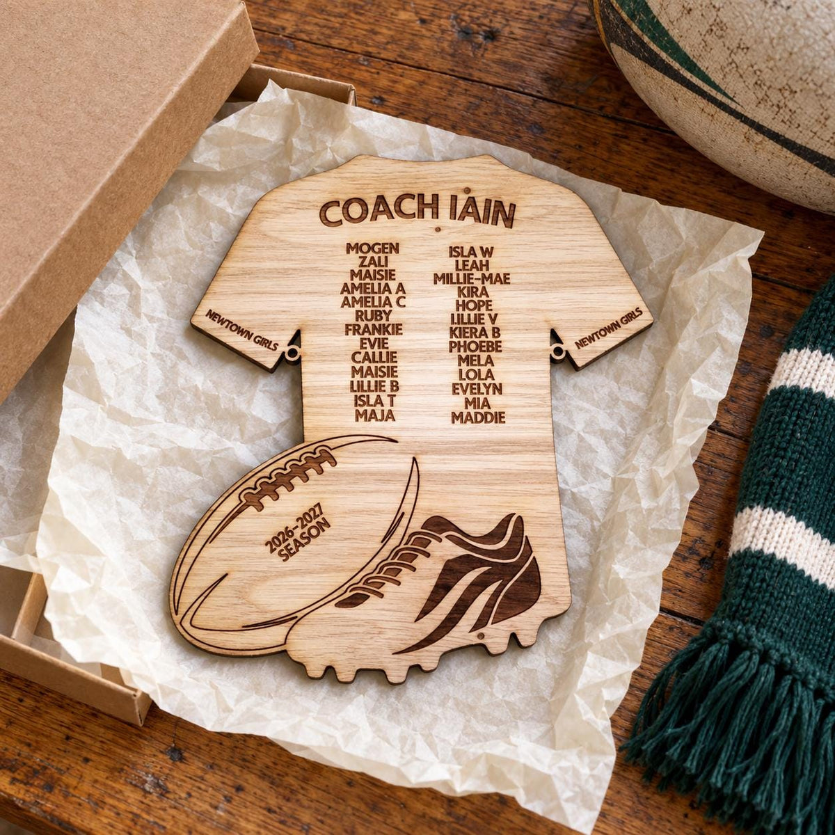 Personalised wooden rugby coach gift plaque with coach and player names on a rugby shirt design, featuring rugby ball and boot details.